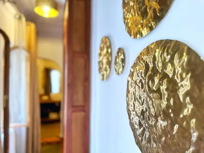 a wall with gold plates on a wall at Riad Nesayam - Riad Privatisé - 3 Suites - Piscine Chauffée in Marrakech