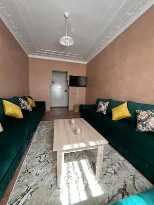a living room with a green couch and a coffee table at Superbe appartement au porte de gueliz in Marrakech