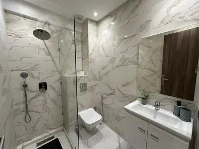 a bathroom with a toilet and a sink and a shower at Résidence Joudad Guéliz in Marrakech