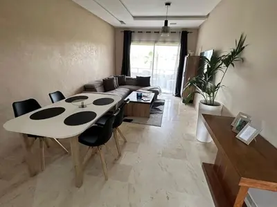 a dining room with a table and chairs in a room at Appartement avec Piscine Prestigia Agate Marrakech in Marrakech