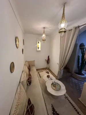 a living room with a couch and a table at Riad Le Saaliya in Marrakech