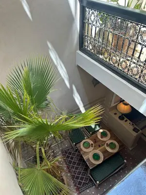 a balcony with two plants next to a staircase at Riad Le Saaliya in Marrakech