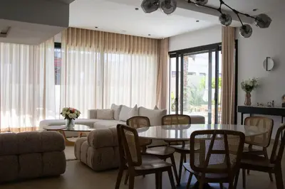 a living room with a couch and a table and chairs at Villa Ayani in Marrakech