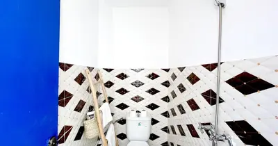 a bathroom with a toilet and a blue wall at Couloirs de la Médina in Marrakech