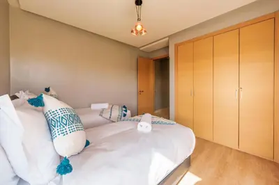 a bedroom with a large white bed with pillows at Relax Front Of Golf-Atlas in Marrakech