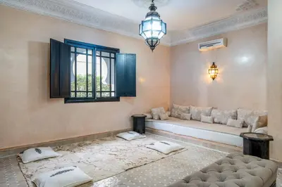 a living room with a couch and a window at Villa Zeitoune - 8 pers - Piscine - Marrakech in Marrakech