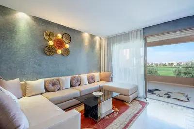 a living room with a couch and a table at Relax front of Golf-Pool-Topaze in Marrakech