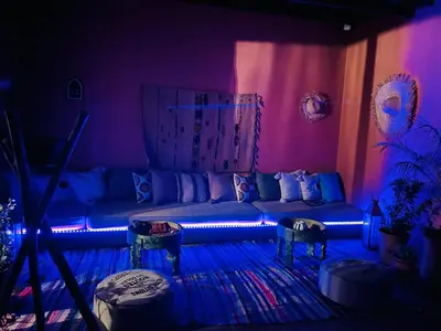 a living room with a couch in a purple room at Loft Gueliz in Marrakech