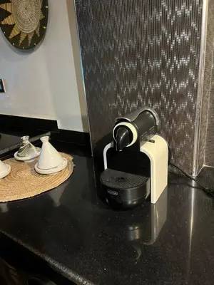a hair dryer sitting on a black counter top at Loft Gueliz in Marrakech