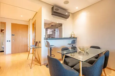 a dining room with a glass table and chairs at PO 10 Appartement de luxe, golf, piscine & club house in Marrakech