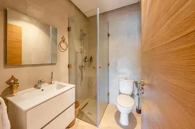 a bathroom with a toilet and a sink and a shower at Chic Escape Sunny Terrace Pool Cenima Bed Fiber Wi-Fi in Marrakech