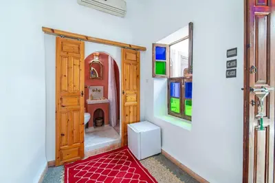 a bathroom with a door and a red rug at Riad Khadoj-Marrakech-Traditional in Marrakech