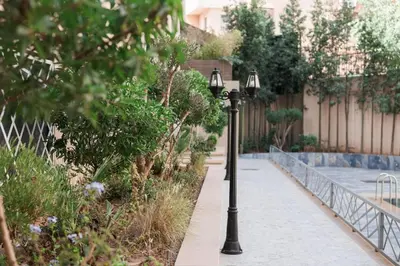 a couple of street lights on a sidewalk at Appartement pour famille ou couple à Marrakech in Marrakech