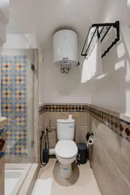 a small bathroom with a toilet and a shower at Gueliz Luxury Apt with Pool Self Check In 24 7 Security in Marrakech
