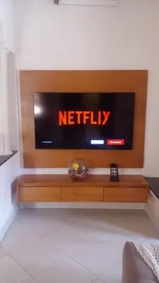 a television on a wall in a living room at Calm Cosy Villa in Marrakech