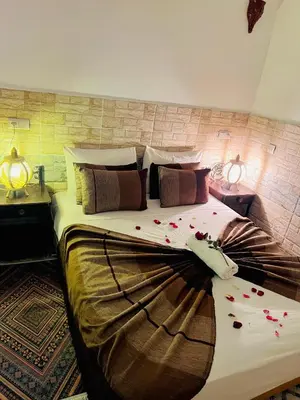 a bedroom with a large bed with flowers on it at Al Bahja family in Marrakech