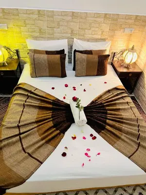 a bed with flower petals on it in a room at Al Bahja family in Marrakech
