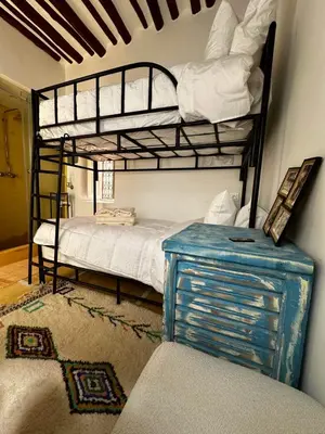 a bedroom with two bunk beds and a blue cabinet at Little 24 in Marrakech