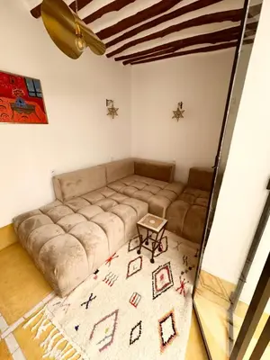 a living room with a large couch and a table at Little 24 in Marrakech