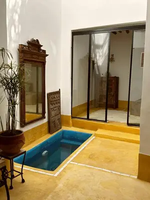 a pool in the middle of a room with windows at Little 24 in Marrakech