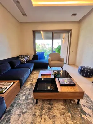 a living room with a blue couch and a coffee table at Golf stay with Atlas view at Marrakech! in Marrakech