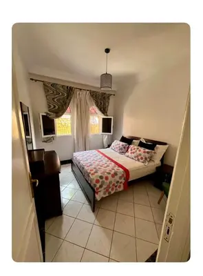 a bedroom with a bed and a window at Tigami in Marrakech