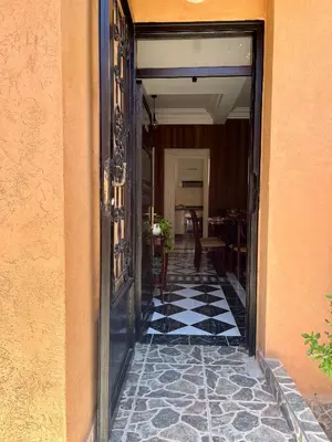an open door to a hallway with a tile floor at Tigami in Marrakech