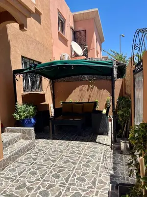 a patio with a green umbrella on a building at Tigami in Marrakech