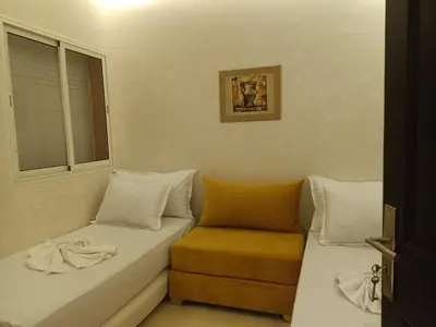 a small room with a couch and a window at Appartement Bayt Atik in Marrakech