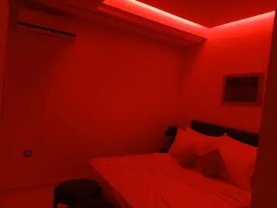 a red room with a bed with red lighting at Appartement Bayt Atik in Marrakech