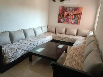 a living room with a couch and a coffee table at Appartement Bayt Atik in Marrakech