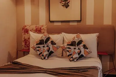 a bed with two pillows on top of it at Riad VUE D'AGDAL in Marrakech