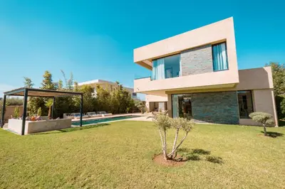 a house with a yard in front of it at Villa Hicham Golf Marrakech in Marrakech