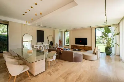 a living room with a glass table and chairs at Villa Hicham Golf Marrakech in Marrakech