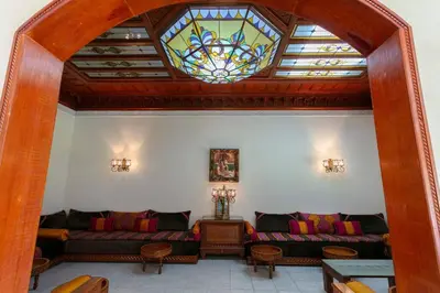 a living room with two couches and a stained glass window at Villa Dar Sultan - Marrakech in Marrakech