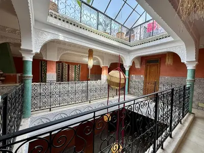 a balcony in a building with a glass ceiling at Riad Flottement Des Songes in Marrakech