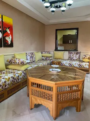 a living room with a couch and a coffee table at Cosy Appartement Avec Piscine in Marrakech