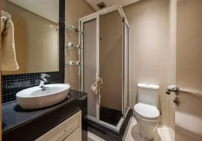 a bathroom with a sink and a toilet and a shower at Poolside Apartment's-Green View in Marrakech