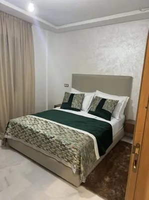 a bedroom with a large bed in a room at appartement à Gueliz in Marrakech