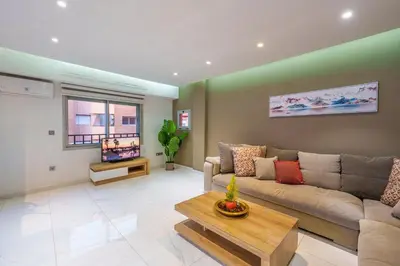 a living room with a couch and a tv at Luxury studio Center Gueliz in Marrakech