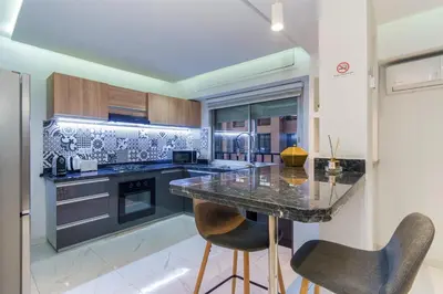 a kitchen with a marble counter and two chairs at Luxury studio Center Gueliz in Marrakech