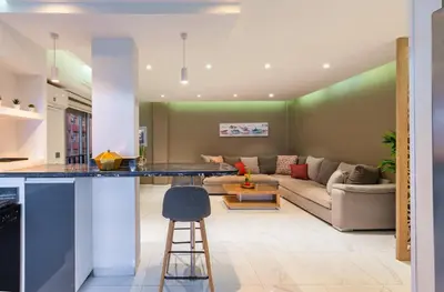 a kitchen and living room with a bar and a couch at Luxury studio Center Gueliz in Marrakech
