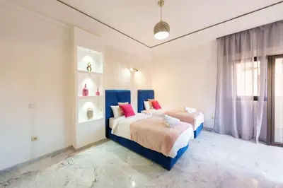 a bedroom with two beds and a window at Luxury Place M Avenue in Marrakech