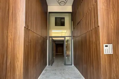 a hallway in a building with wooden walls at Luxury Apartment Gueliz, Cinema Bedroom Experience in Marrakech
