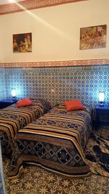 two beds sitting next to each other in a room at RIAD DAR KADER D in Marrakech