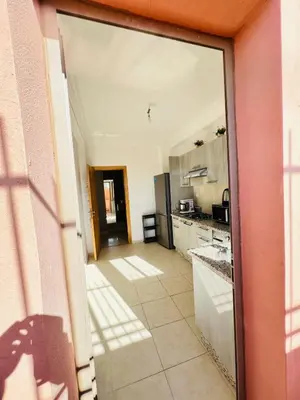 a kitchen with a large glass door leading into a room at Les palmiers de marrakesh in Donar Zratna