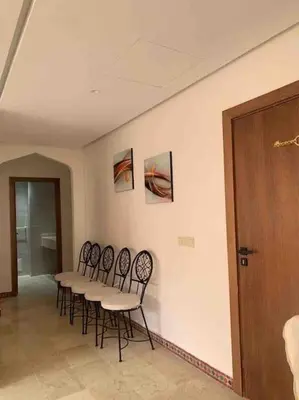 a group of chairs around a table in a room at Appart Premium Village Marrakech in Marrakech