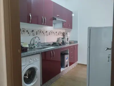 a kitchen with purple cabinets and a washing machine at Chill Apartment Portes Gueliz in Marrakech