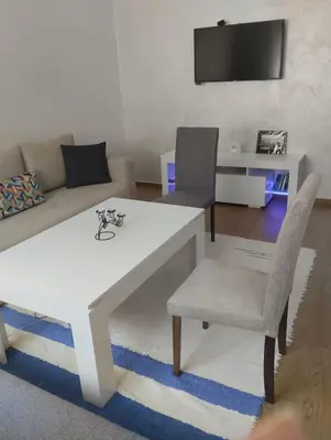 a living room with a white table and chairs at Chill Apartment Portes Gueliz in Marrakech