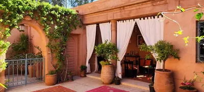 a courtyard with potted plants and a gate at Marrakech, villa 7 Harmonia, pour 6 personnes avec piscine privée in Marrakech